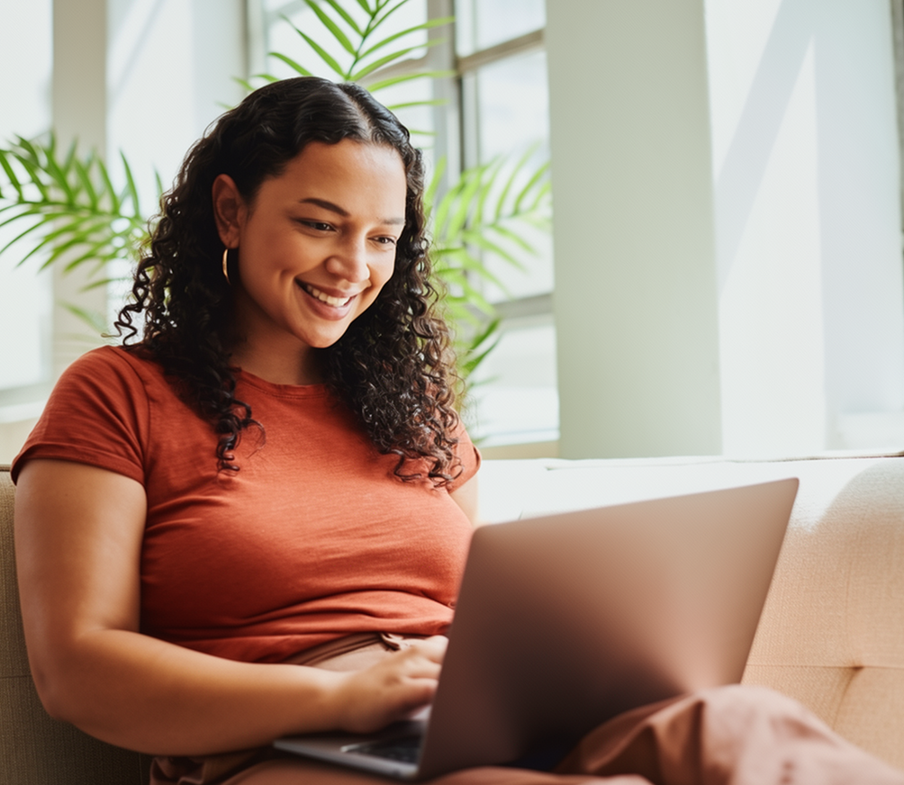 Woman smiling at her laptop – online psychiatry in Vancouver, WA